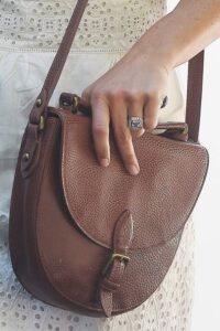 Pippa Middleton brown purse and wearing an engagement ring on her right hand.